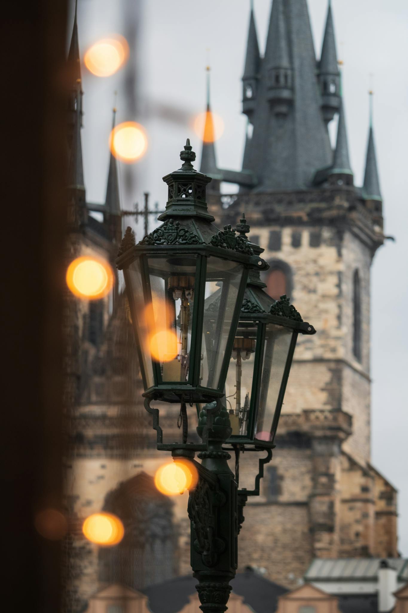 A street lamp with lights in front of a church